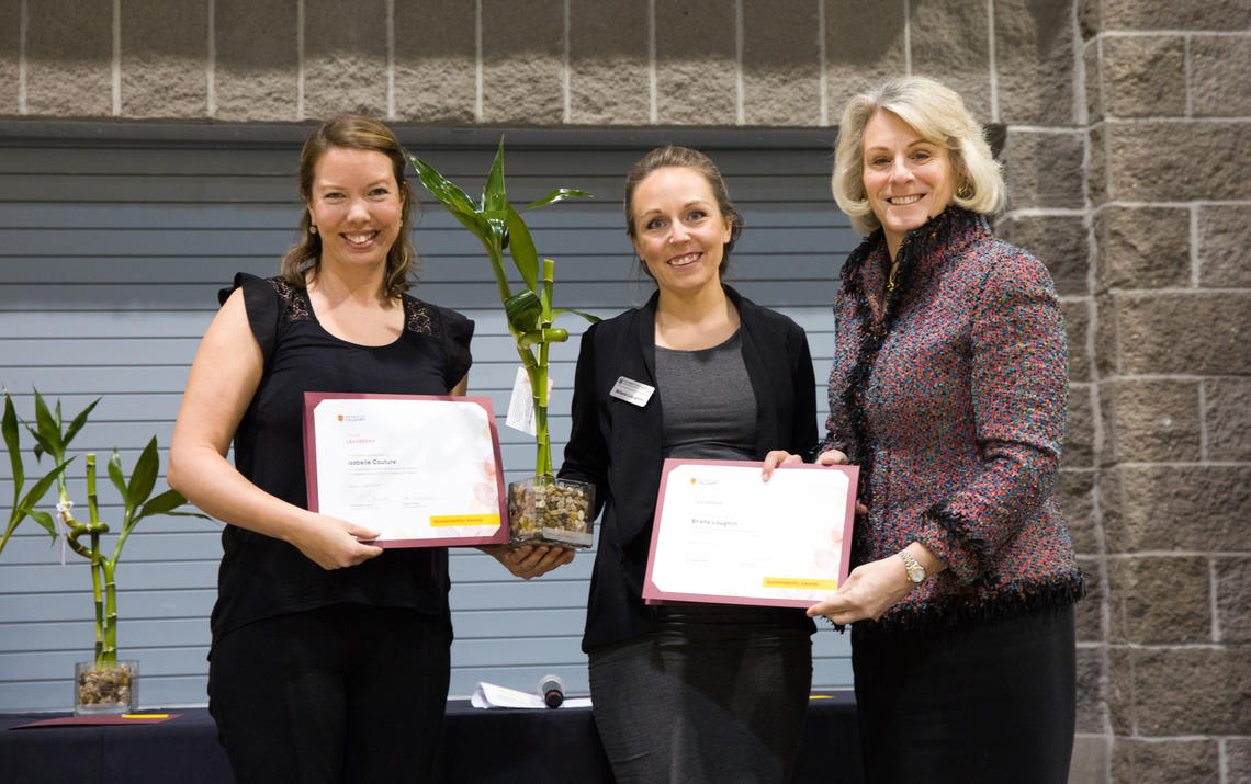Isabelle Couture, left, and Briana Loughlin receive a Sustainability Award from President Cannon at the March 21 Sustainability Awards.