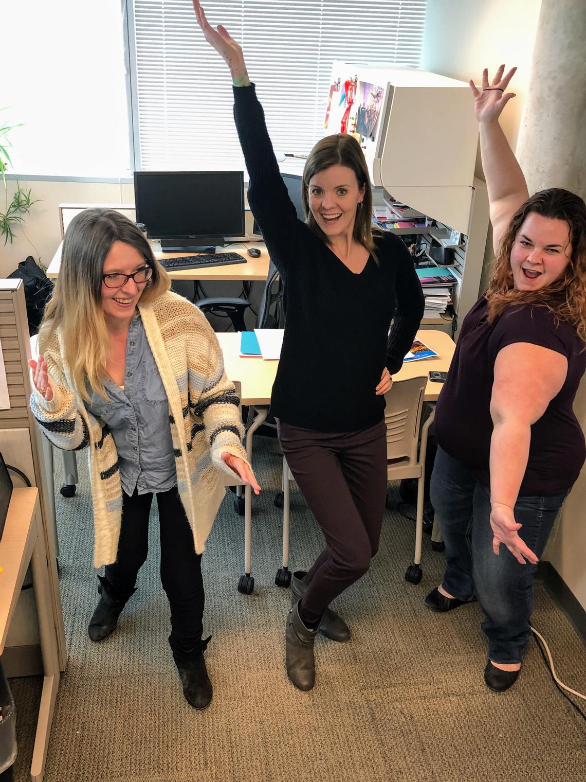 Cumming School of Medicine’s Working Our Way to Wellness (WoWW) members dance in their office, from left: Katie Flynn, Stephanie Hawes and Jennifer McCarty.