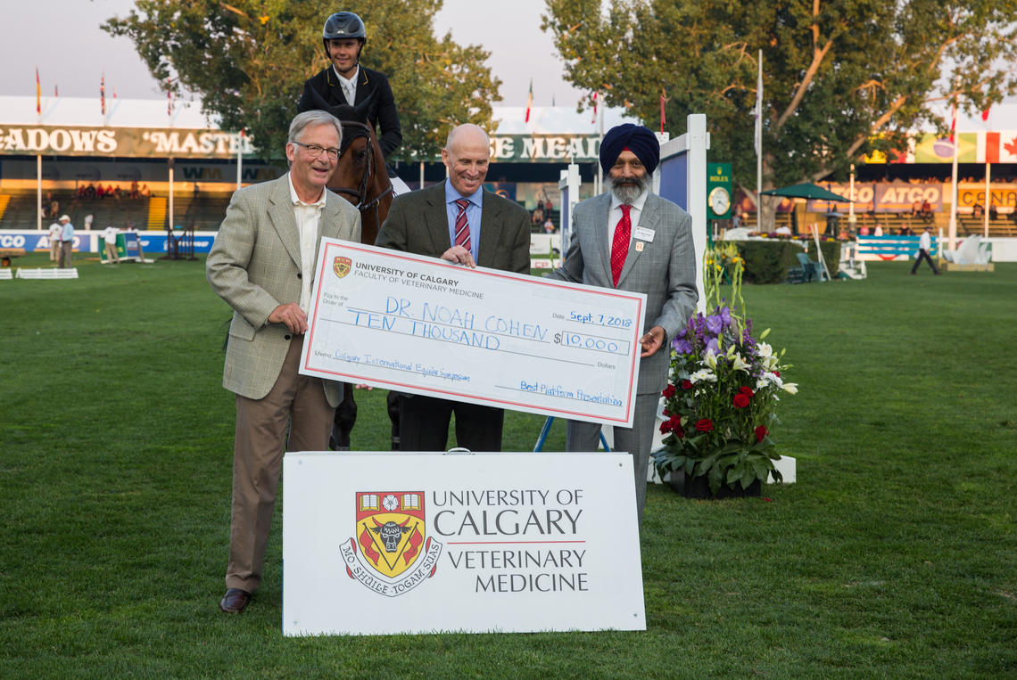 Noah Cohen, centre, was awarded the symposium's grand prize during the Spruce Meadows Masters event, by head judge Hugh Townsend, left, and Baljit Singh.