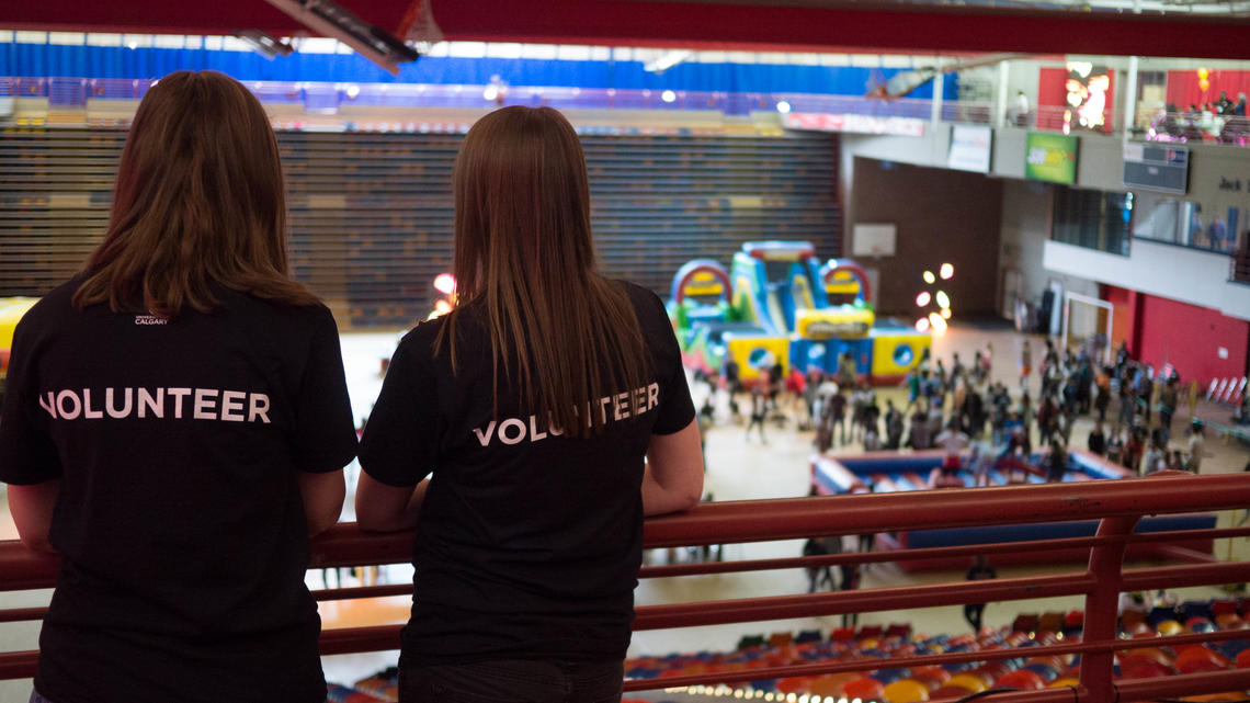 Mandy McCaughley and another volunteer watch the action on the floor during last year's UCalgary Strong Festival. This year volunteers will receive a free UCalgaryStrong hoodie and lunch.