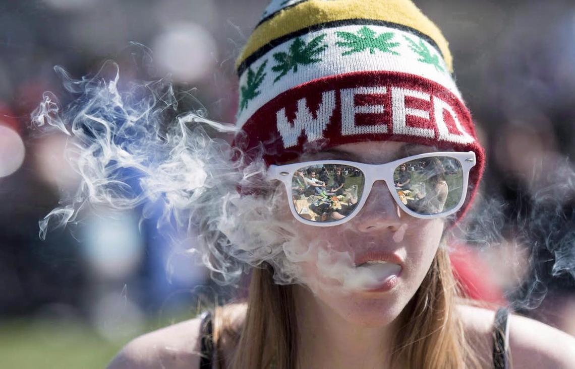 Fear-mongering ad campaigns working well? A young woman exhales while smoking a joint during the annual 420 marijuana rally on Parliament Hill in 2016.