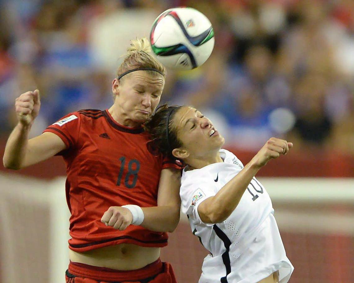 Germany’s Alexandra Popp (18) and USA’s Carli Lloyd (10) battle for a header during the 2015 Women’s World Cup. Studies have shown female soccer players are more susceptible to concussions.
