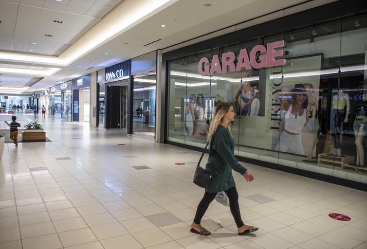 A shopper walks in the relatively empty Bayshore Shopping Centre mall in Ottawa on its first day open as part of Stage 2 of Ontario’s plan to lift COVID-19 lockdowns.