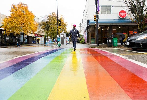 NDP Leader Jagmeet Singh crosses the road at a rainbow crosswalk during a campaign stop in Vancouver, B.C., in 2019. 