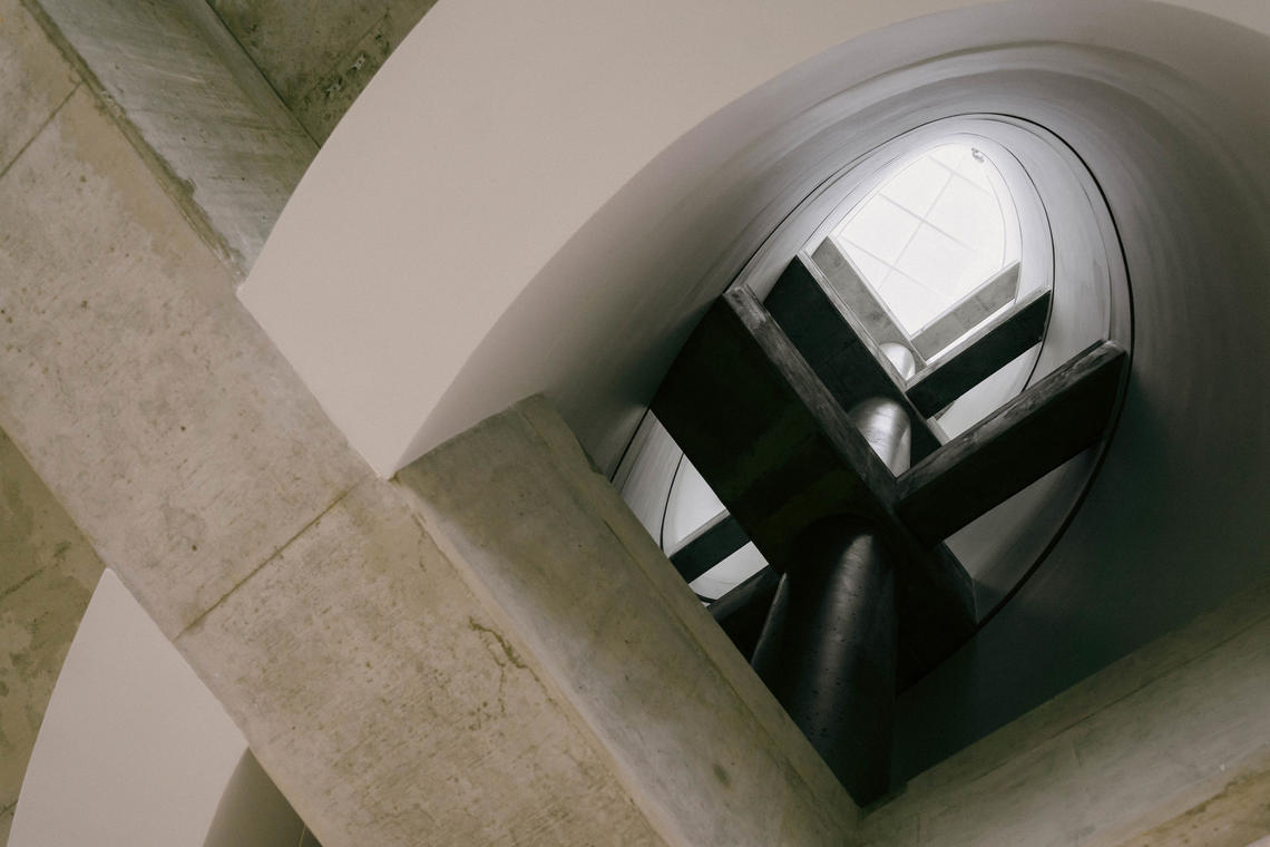 Concrete cylinders called vessels allow warm air to rise between floors as part of natural heating and cooling systems in Hunter Student Commons. 