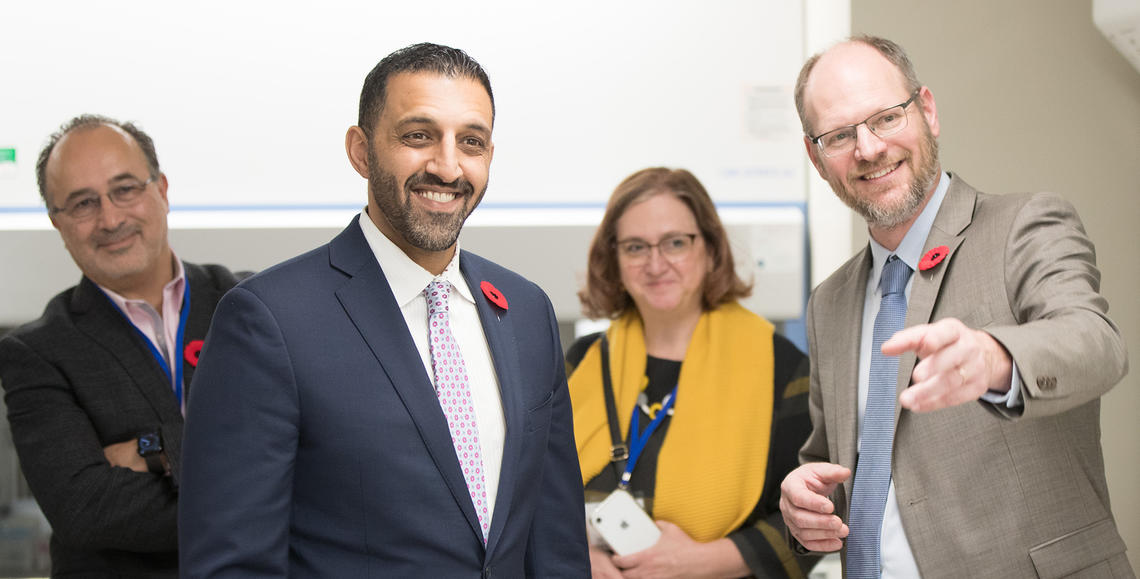 Ian Lewis shows MP George Chahal the ACAD labs during a tour at the ACAD launch.