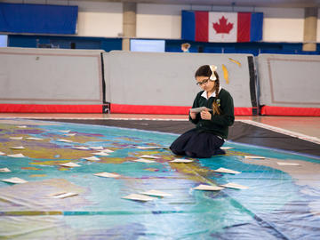 Student participant with the Canadian Geographic floor maps