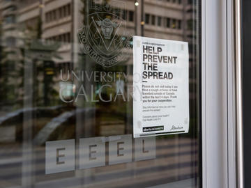 Sign on campus door says Help prevent the spread