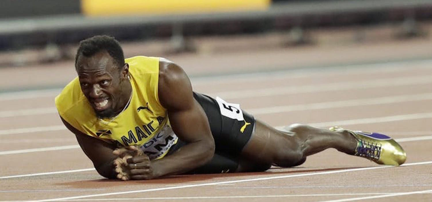 Jamaica’s Usain Bolt lays on the track after suffering a hamstring injury in the final of the men’s 4x100m relay during the World Athletics Championships in London on Aug. 12, 2017. (AP Photo/Frank Augstein)