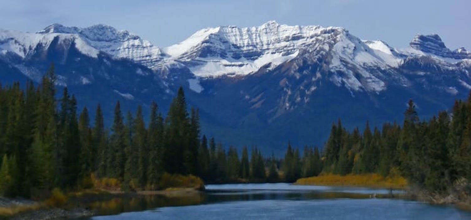 A photo of Stoney Squ-w Mountain in Banff by the Bow River. (Shutterstock)