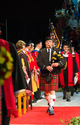 Alf Miller pipes in the stage party during University of Calgary convocation exercises. This year, he's playing a Canadian-penned tune called At Long Last.