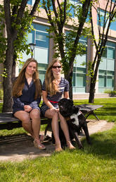 Tiana Knight, right, graduated from the Faculty of Law at the University of Calgary along with her good friend Sarah Patrick and Tiana’s guide dog, Cashmere. Photo by Riley Brandt, University of Calgary