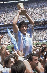 Superstar Diego Maradona holds up the World Cup trophy in 1986. The World Cup tournament may prompt some people to get out and play themselves, leading to possible injuries.