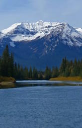 A photo of Stoney Squ-w Mountain in Banff by the Bow River. (Shutterstock)