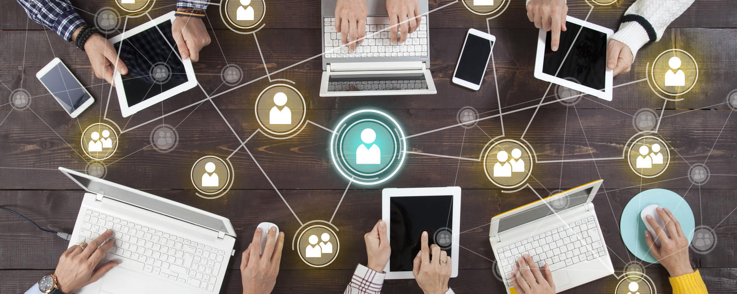 A group of people with laptops, networking