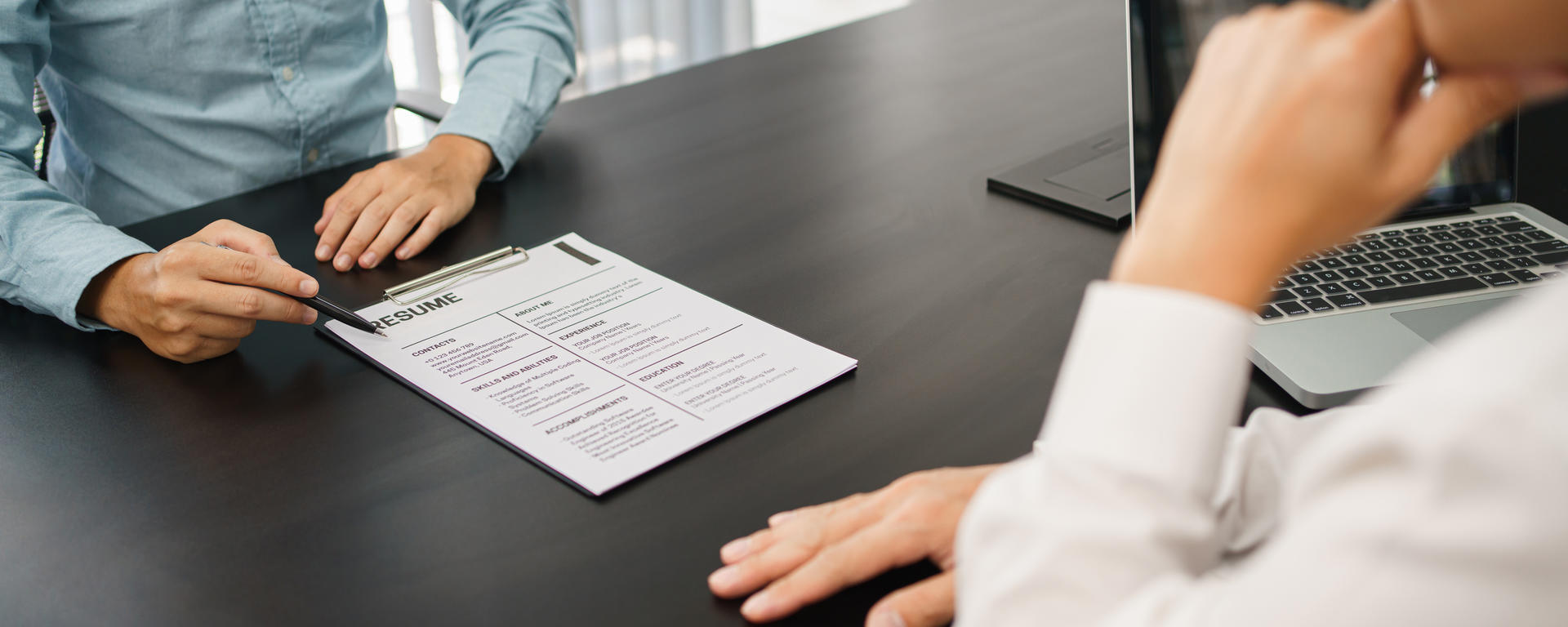 Two individual's reviewing a resume