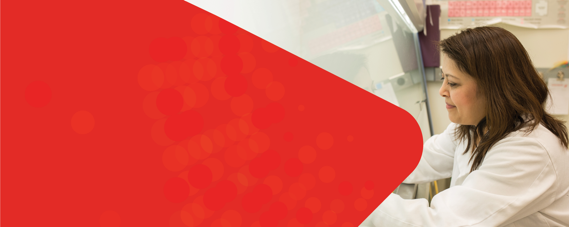 A doctor with long brown hair and lab coat