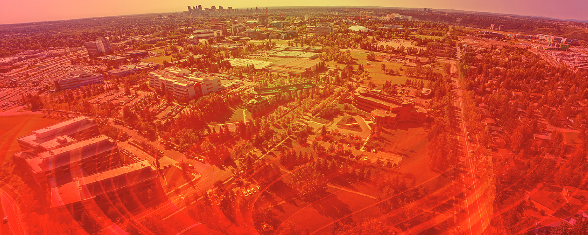 A drone photo of campus with a red overlay