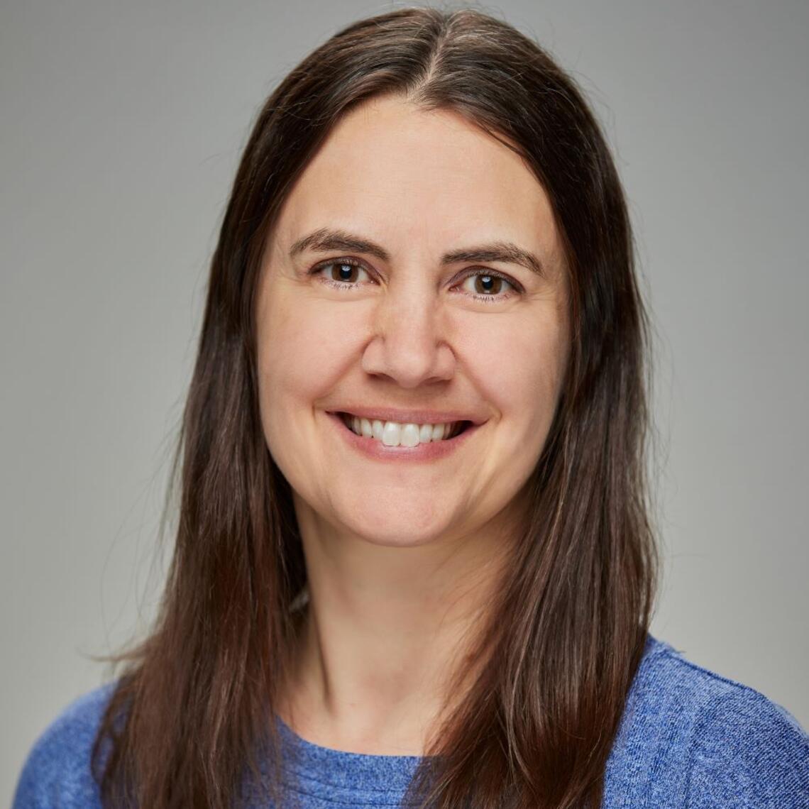 A photo of Dr. Climie smiling at the camera.