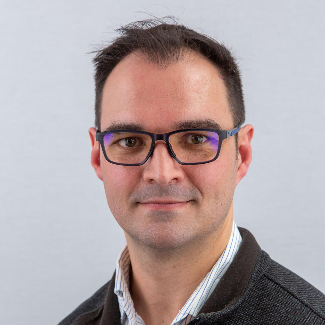 A photo of Dr. Prinsloo smiling at the camera.