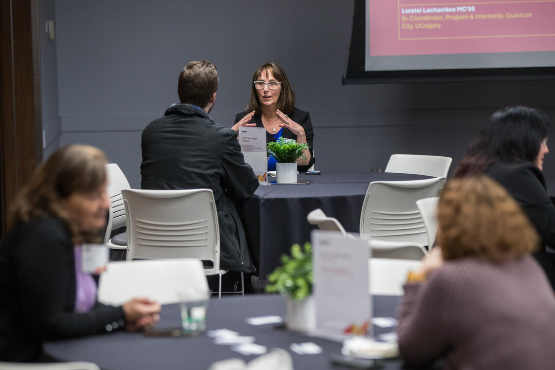 woman and man speaking at a table at last year's Grow Your Career Conference.