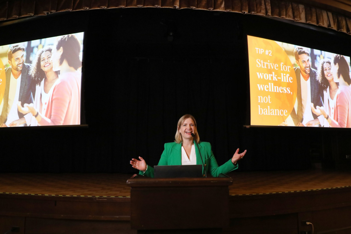 Dr. Laura Hambley Lovett speaking on stage at an event.