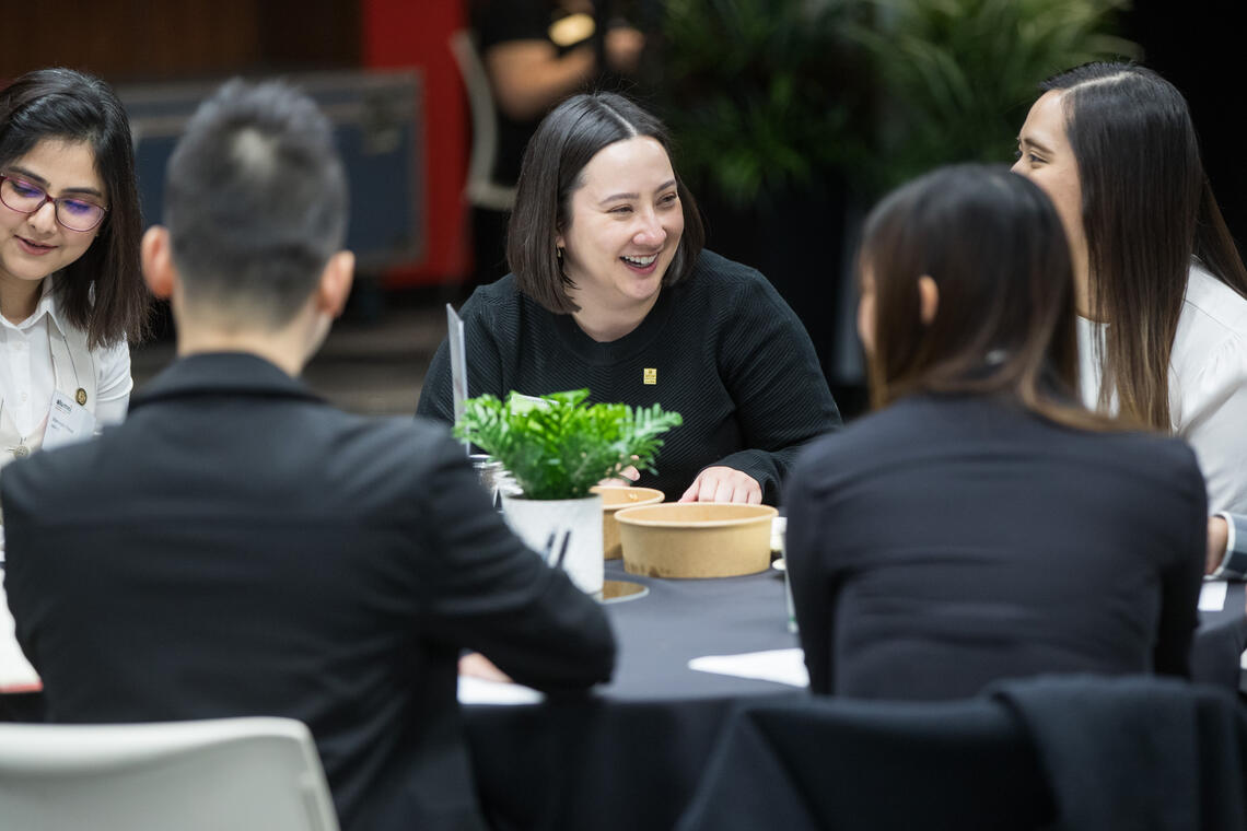 a group of young people at table networking at last year's Grow Your Career Conference.