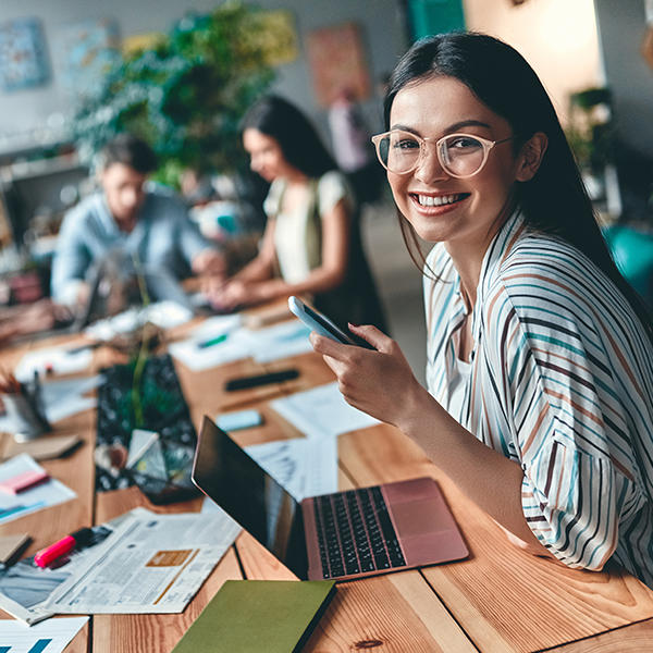Smiling woman at in a co-working space