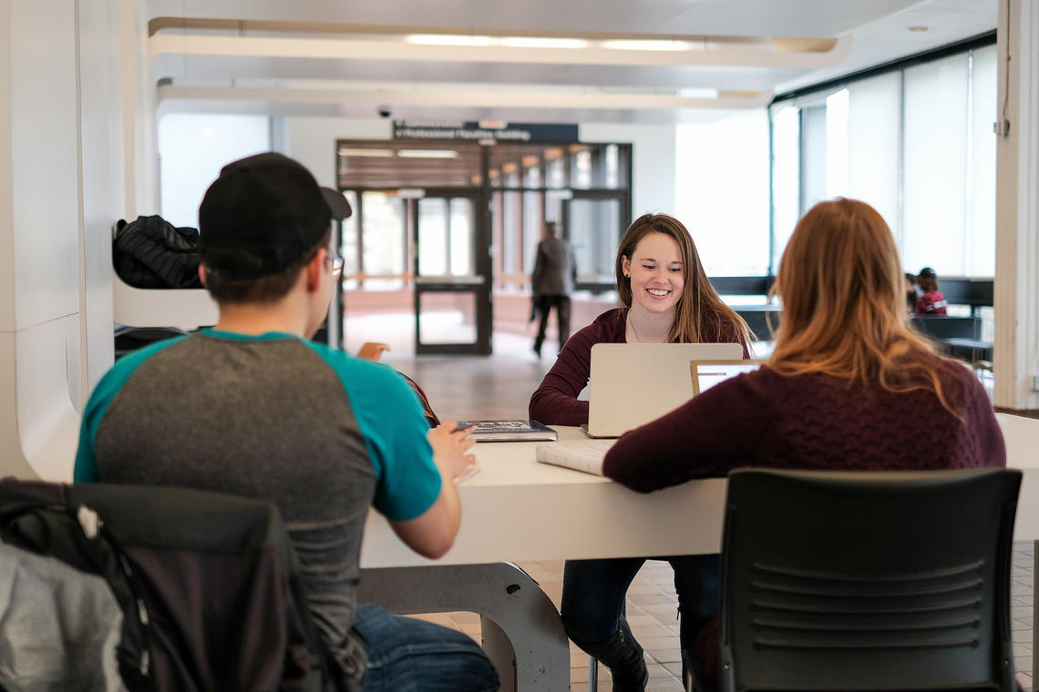 Three students talking Three students talking