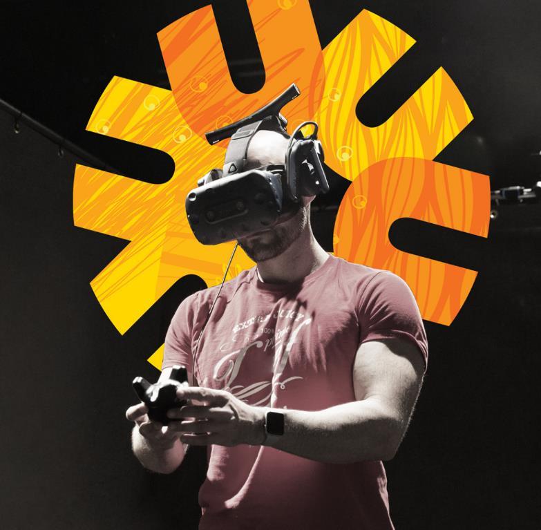 man holding VR with UCalgary Start Something logo behind him