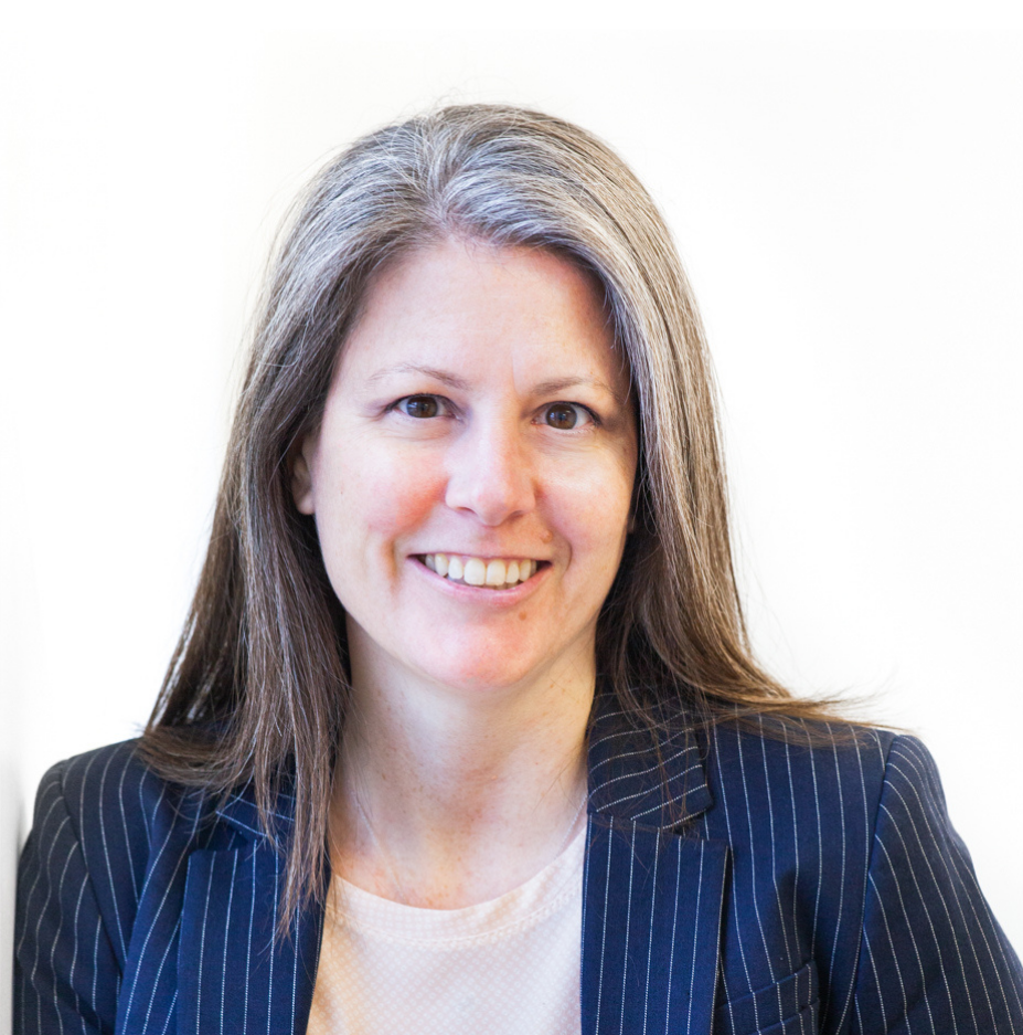 A photo of Jane wearing a blue pinstripe blazer over a white shirt.