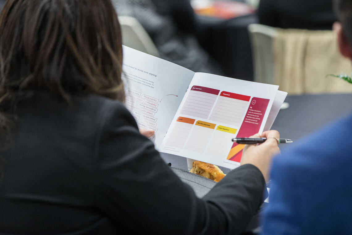 a person looking at a manual at last year's Grow Your Career Conference.