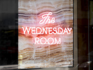 A neon sign grabs your attention as you walk by on Stephen Avenue Mall.