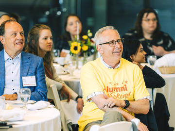 UCalgary President Ed McCauley (yellow shirt) sits in on the discussion.
