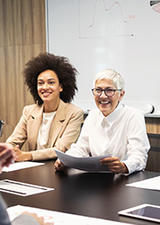 two generations of professionals interact in a meeting
