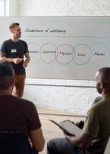 man giving presentation on dimensions of well-being