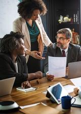 young professional woman leads a meeting in a boardroom