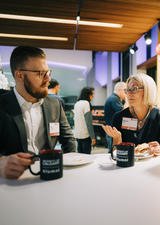 Three people chatting over coffee