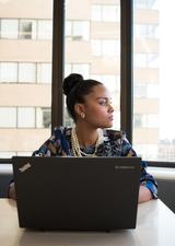 Young professional woman deep in thought