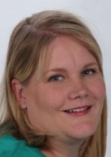 Portrait of Annette Levy wearing a teal green shirt