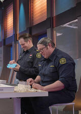 Two local firefighters building something with lego blocks