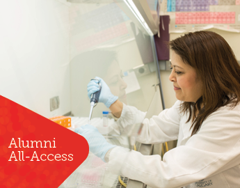 A woman uses a pipette in a lab