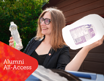 A person smiling holding recycled items.